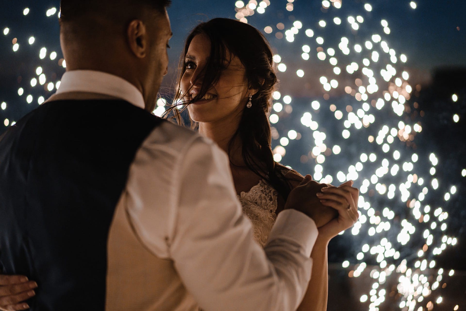 Married Couple happily dancing in front of fireworks