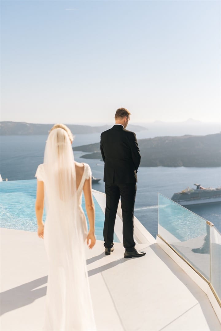 Groom and Bride looking at the caldera at Dana Weddings