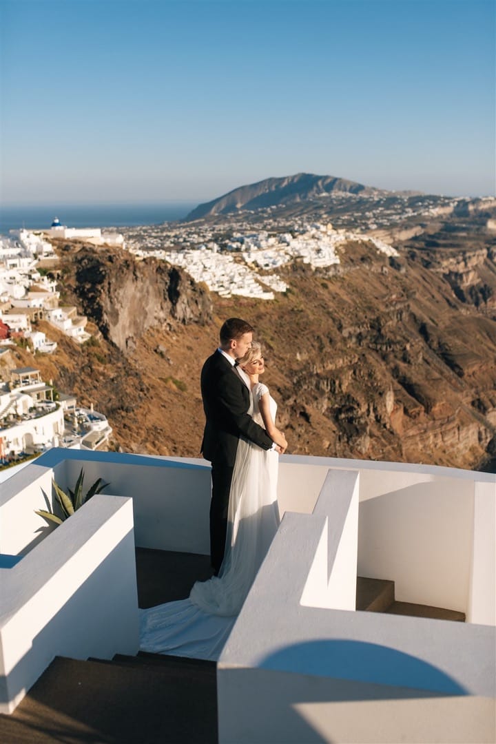 Married Couple on a romantic moment looking at Santorini’s Caldera